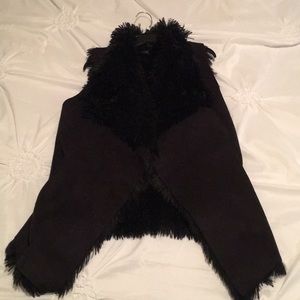 Black furry vest with suede like outside. Pockets
